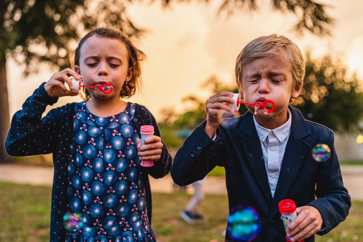 Kids playing with soap bubbles at a wedding